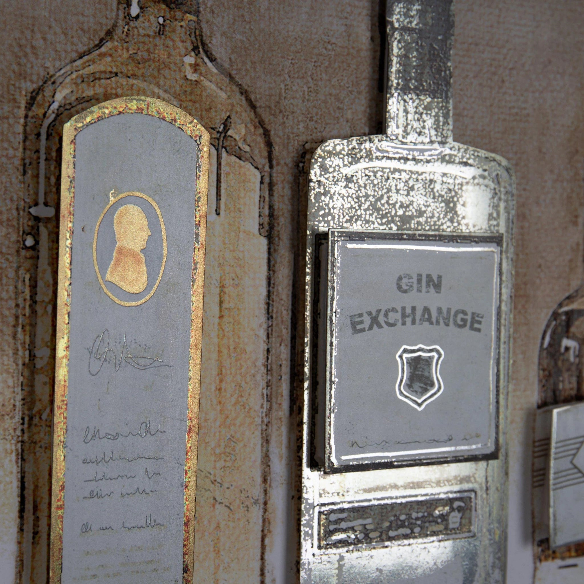 Close-up detail of vintage liquor bottles with raised metallic paper labels.