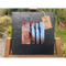 A tile mounted on slate featuring a textured painting of bare trees and autumn colours