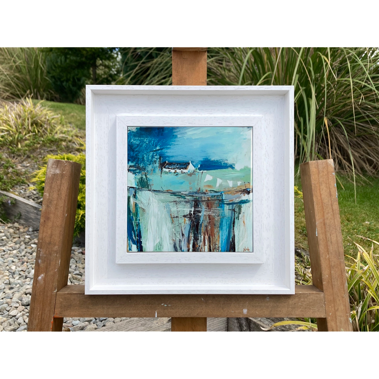 White framed art tile featuring a small white bothy in a vibrant blue setting