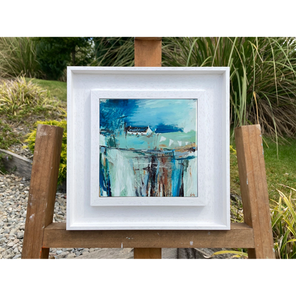 White framed art tile featuring a small white bothy in a vibrant blue setting