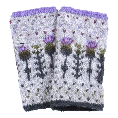 A pair of knitted handwarmers in grey with a repeating thistle pattern and hearts