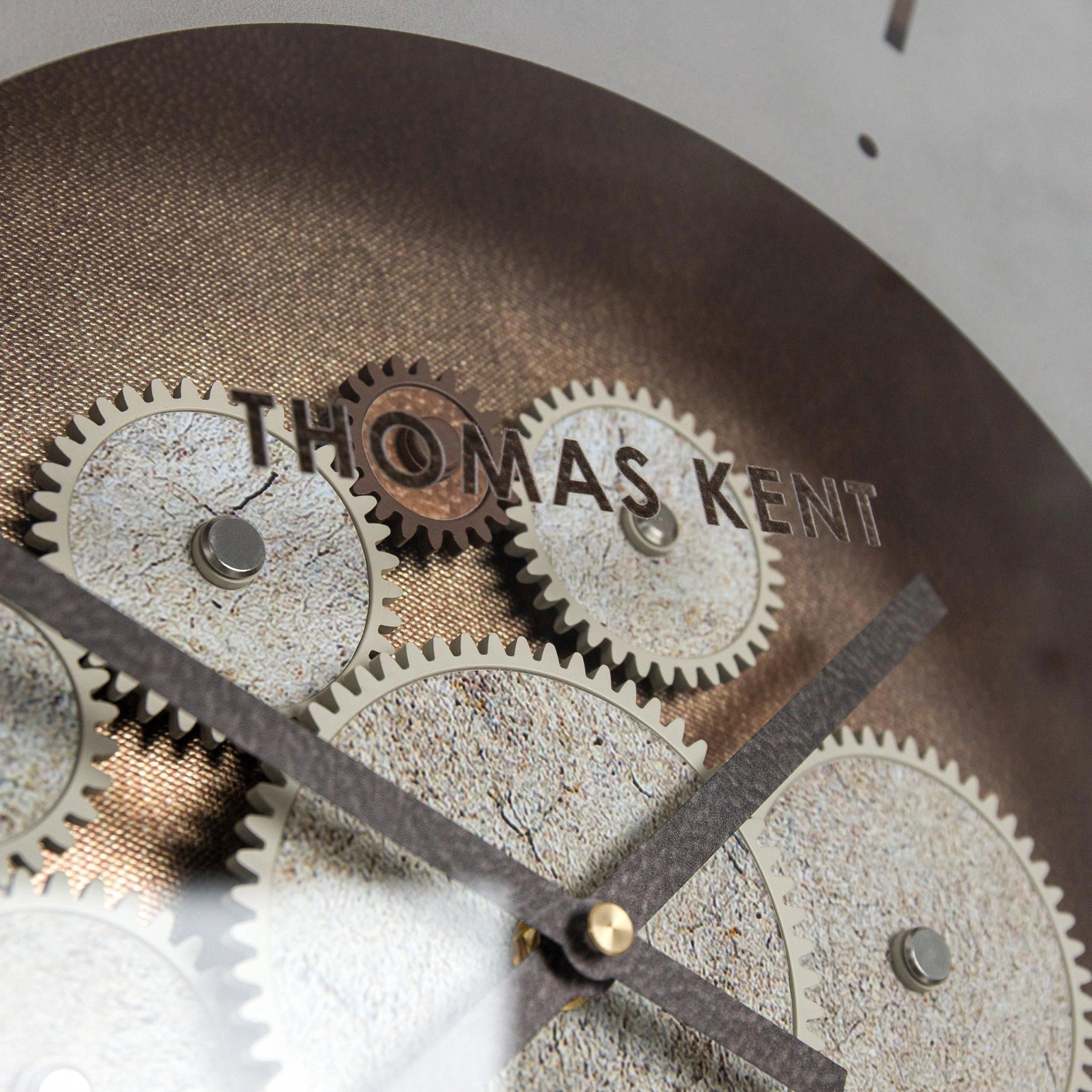 A wall clock with exposed cog design in a bronze colour details