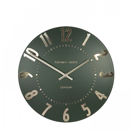 A simple and modern round wall clock in a dark olive green colour with gold hands and numbers