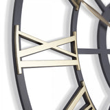 Close-up detail of skeleton wall clock with grey frame and contrasting gold roman numerals.