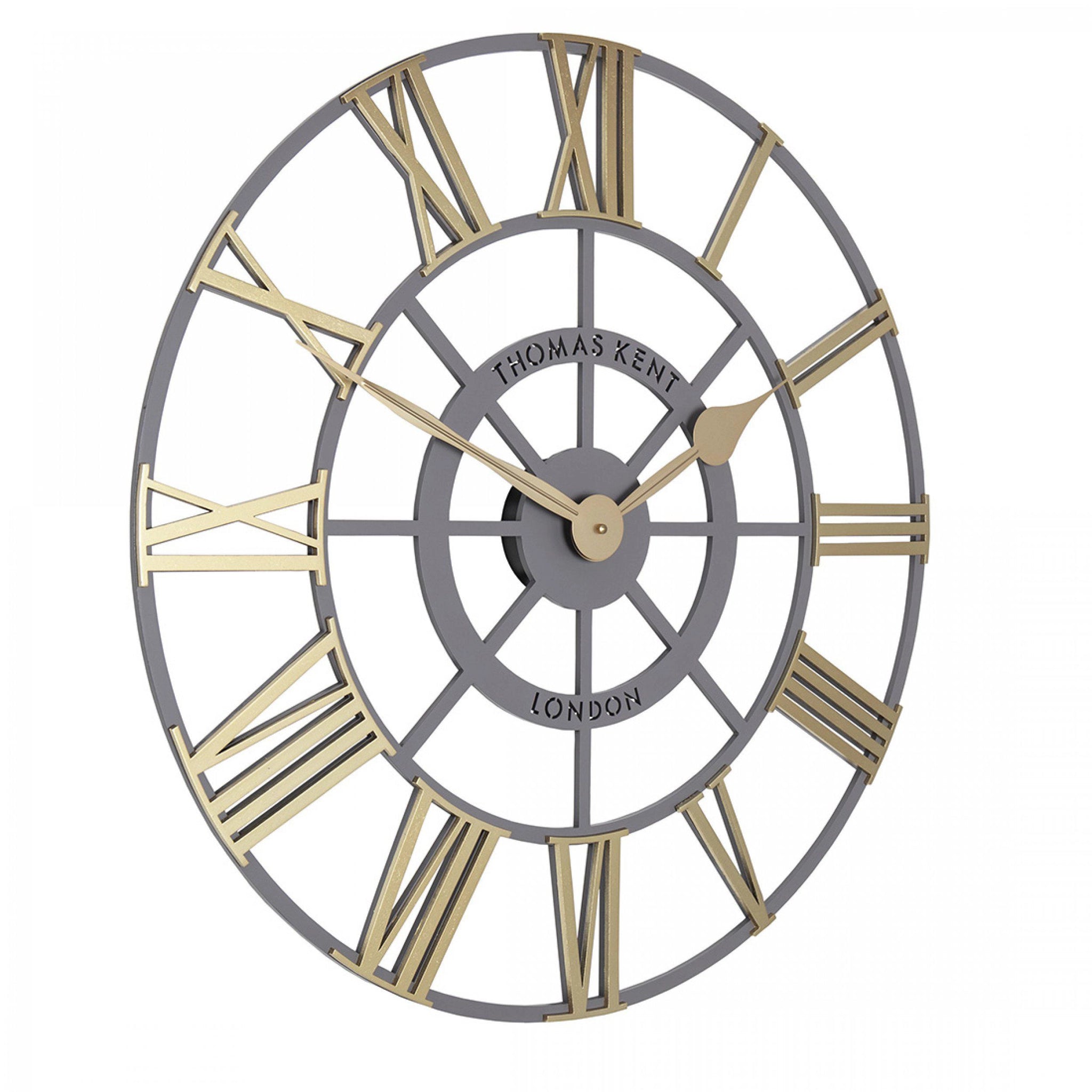 Side view of round skeleton wall clock with grey frame and contrasting gold hands and roman numerals.