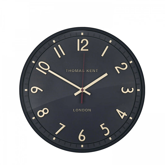A simple and modern round wall clock in a charcoal colour with gold hands and numbers