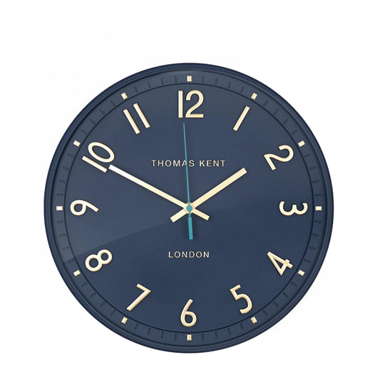 A simple and modern round wall clock in a marine blue colour with gold hands and numbers