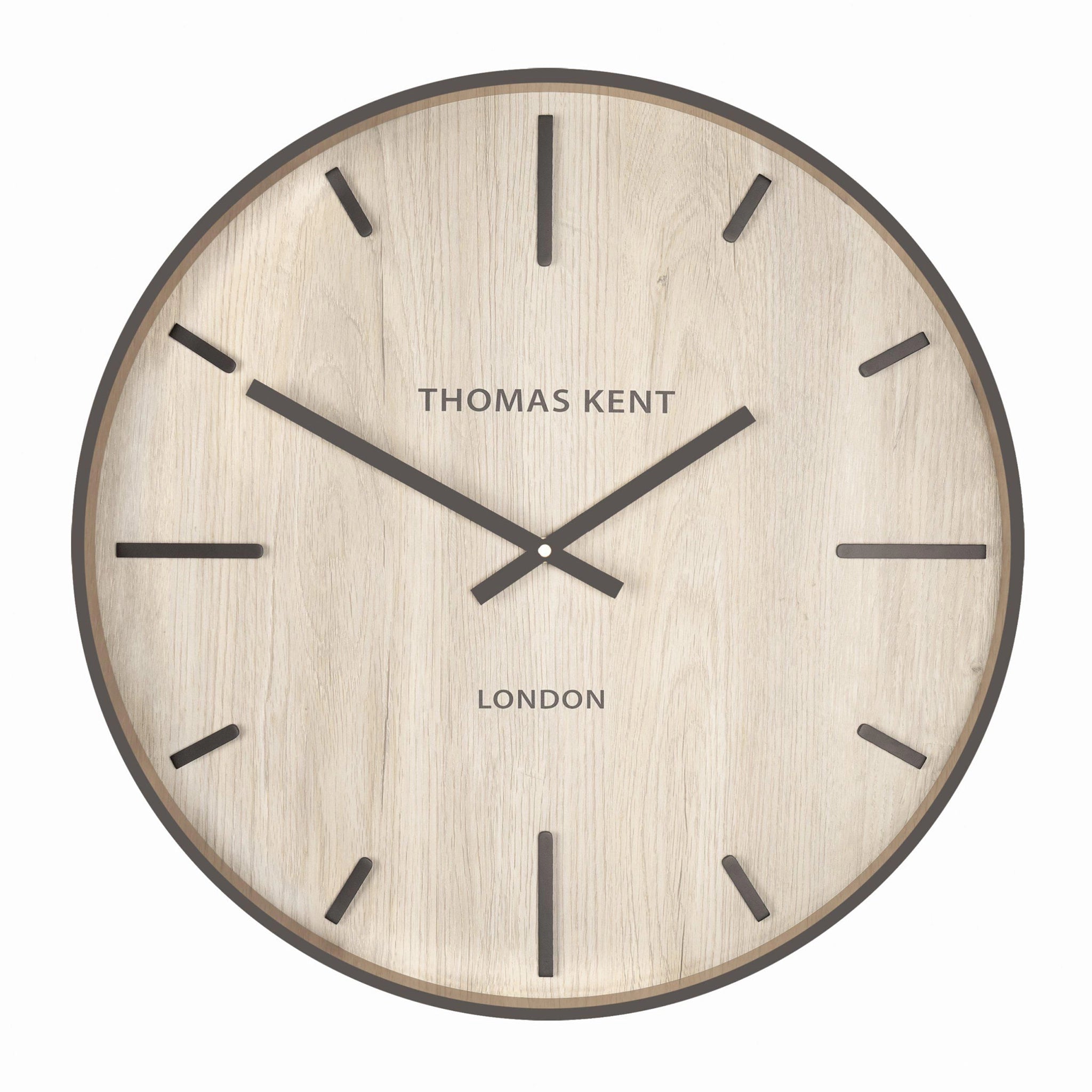 A wall clock with light wood effect face and simple number markings and hands
