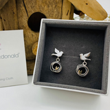 Silver bird earrings with nest shape drops featuring gold heart detail on stud fittings in box