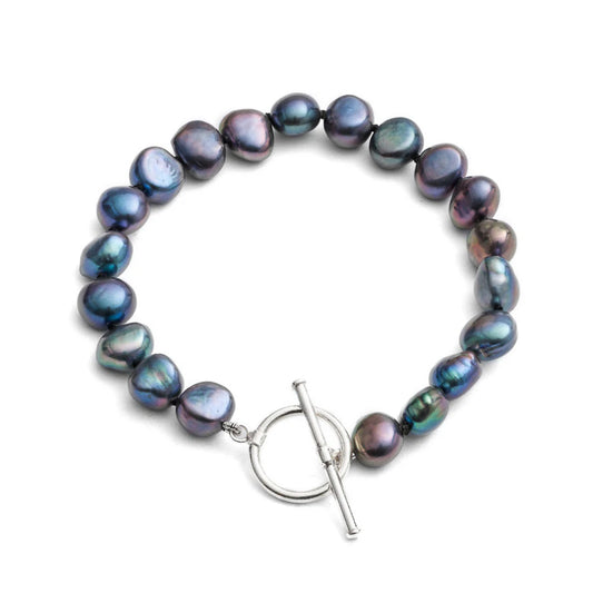 A silver toggle clasp bracelet strung with natural shaped black freshwater pearls
