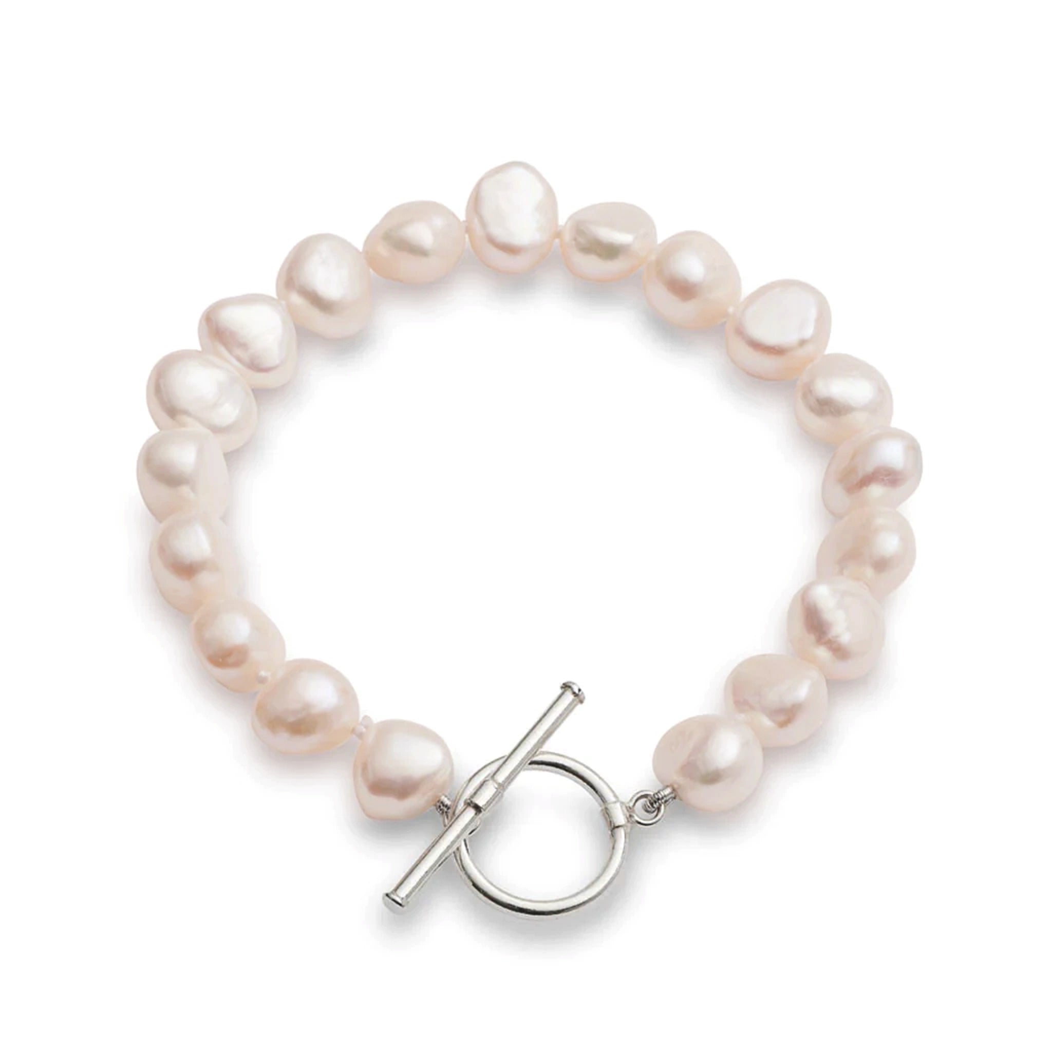A silver toggle clasp bracelet strung with natural shaped pink freshwater pearls