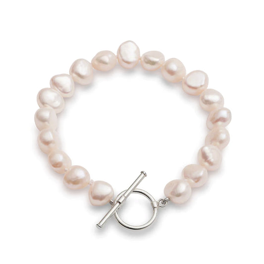 A silver toggle clasp bracelet strung with natural shaped pink freshwater pearls