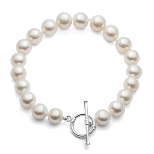 A silver toggle clasp bracelet strung with round shaped white freshwater pearls