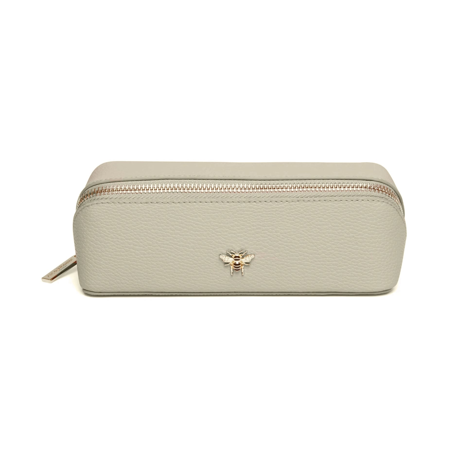 Pistachio green faux leather cosmetic train bag with gold bee emblem and zip closure