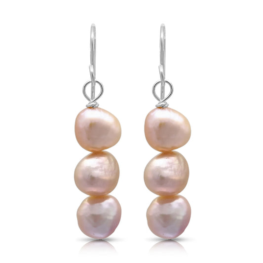 A pair of drop earrings with three stacked natural shaped pink pearls and silver hook fittings
