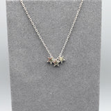 A silver necklace featuring three little stars