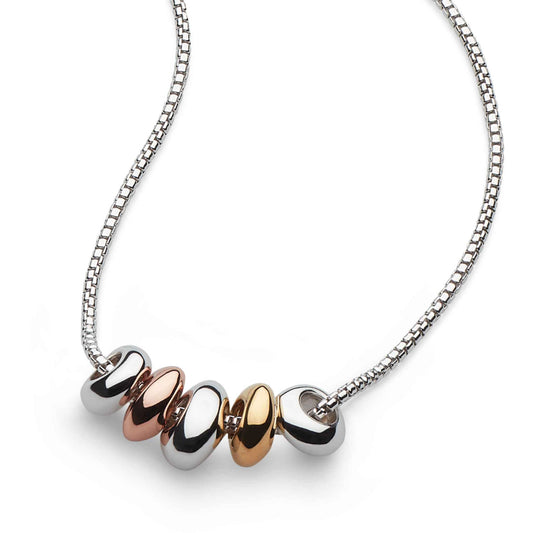 A silver necklace with mixed metal organic pebble shapes