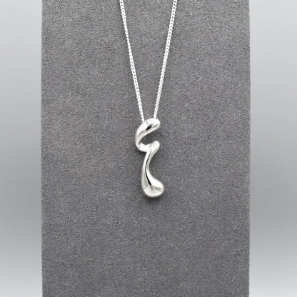 A sterling silver pendant that features a modern design of a long twisted droplet shape