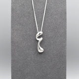 A sterling silver pendant that features a modern design of a long twisted droplet shape