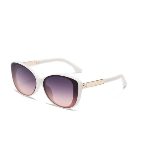 Pair of white cat eye sunglasses with gold metal details on the arms