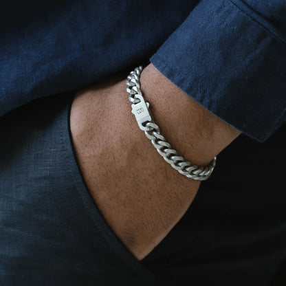 Model wearing a silver chunky chain bracelet made from stainless steel, with a snap clasp fastening