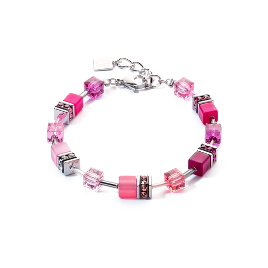 A steel bracelet featuring a variety of bright pink cube shaped stones and glass beads