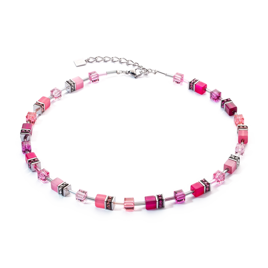 A steel necklace featuring a variety of bright pink cube shaped stones and glass beads