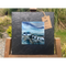 Slate mounted ceramic tile art featuring a painting of a white cottage and washing line