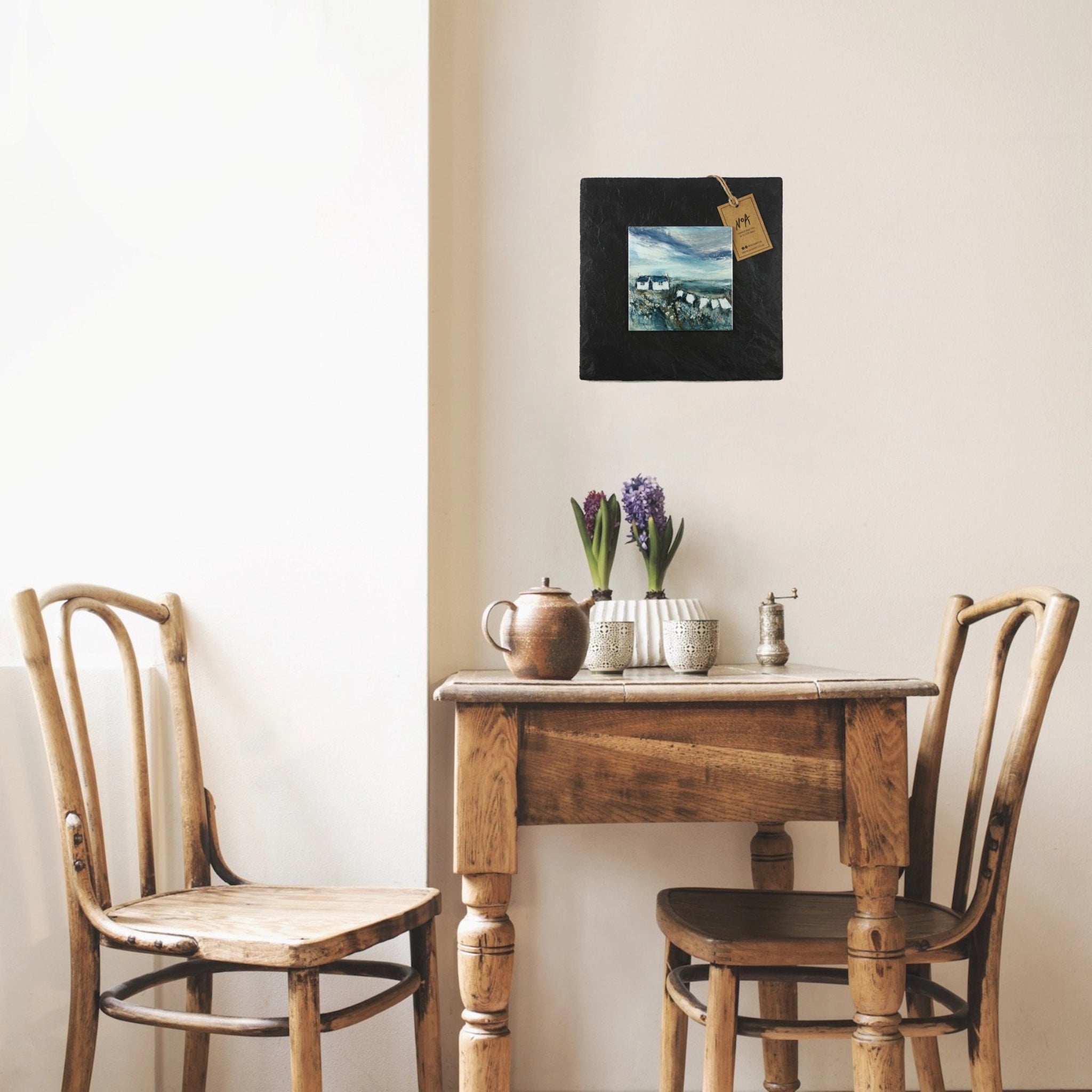 Slate mounted ceramic tile art featuring a painting of a white cottage and washing line hanging