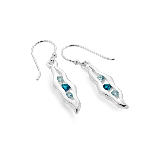 A pair of wave shaped silver drop earrings with blue topaz stones in the centre
