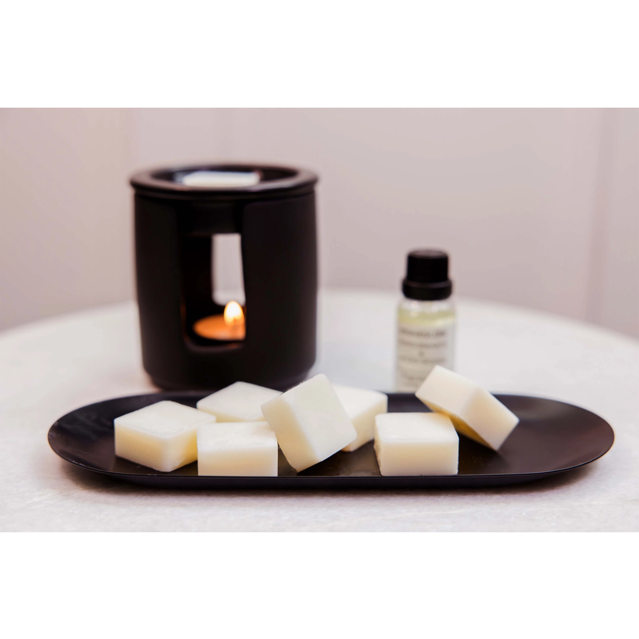 A ceramic black tealight wax melter lifestyle image