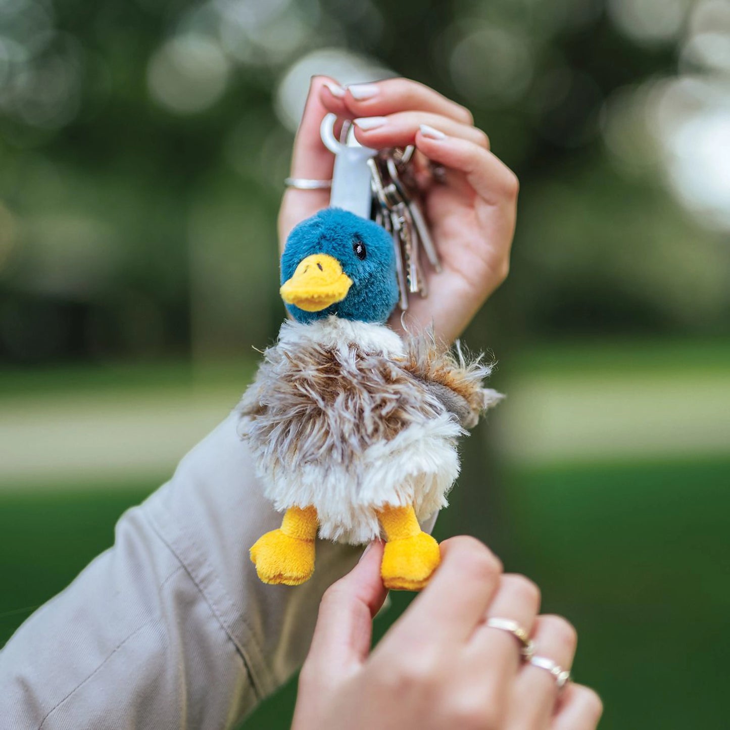 Model holding a plush duck keyring