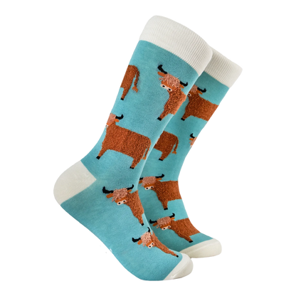 Duck egg blue socks with tufted Highland cows