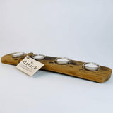 Long wooden tealight holder with four tealight candles in glass holders