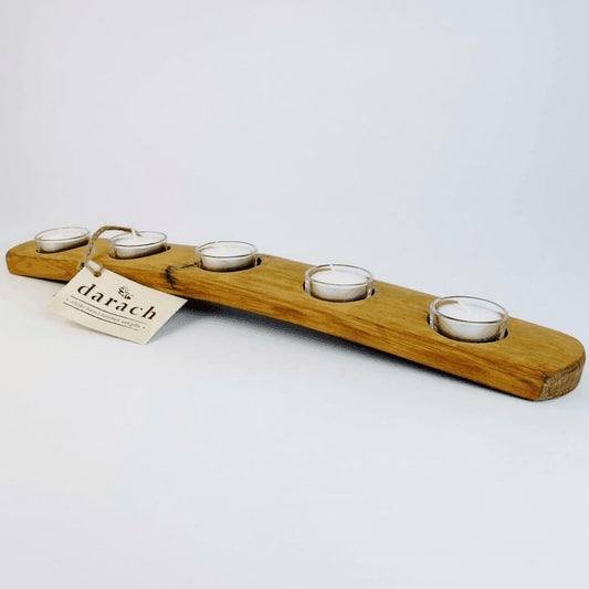 Long wooden barrel stave tealight holder featuring five tealights in glass holders