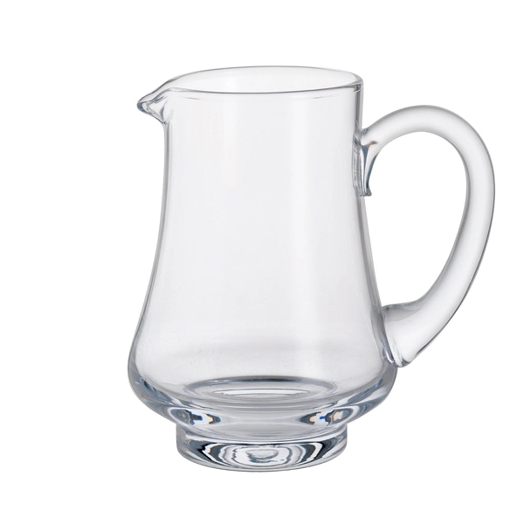 A glass jug with a wide base and handle