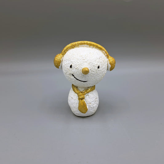 A snowman ornament with gold glitter details wearing earmuffs and a tie.