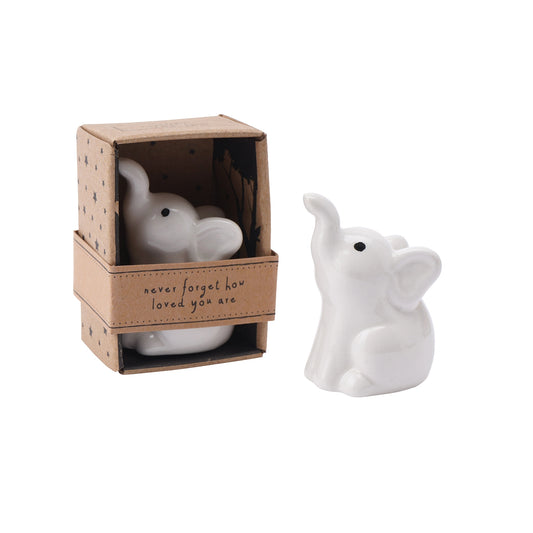 White ceramic elephant figure in a box with a little phrase