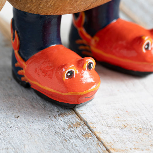 Wooden painted wellies with red crab design on wooden penguin