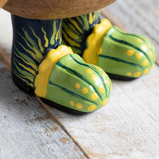 Wooden painted wellies with green jellyfish design on wooden penguin