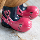 Wooden painted wellies with pink octopus design on wooden penguin