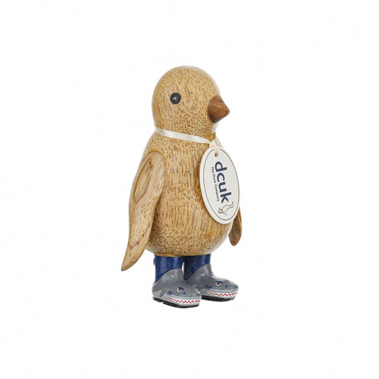 A wooden penguin wearing wellies with grey shark design