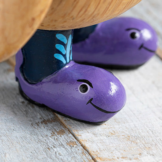 Wooden painted wellies with purple whale design on wooden penguin