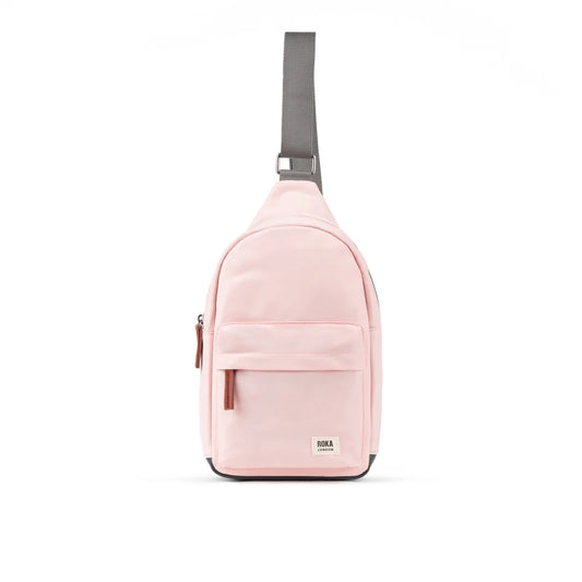 Pale pink crossbody sling bag with grey nylon strap