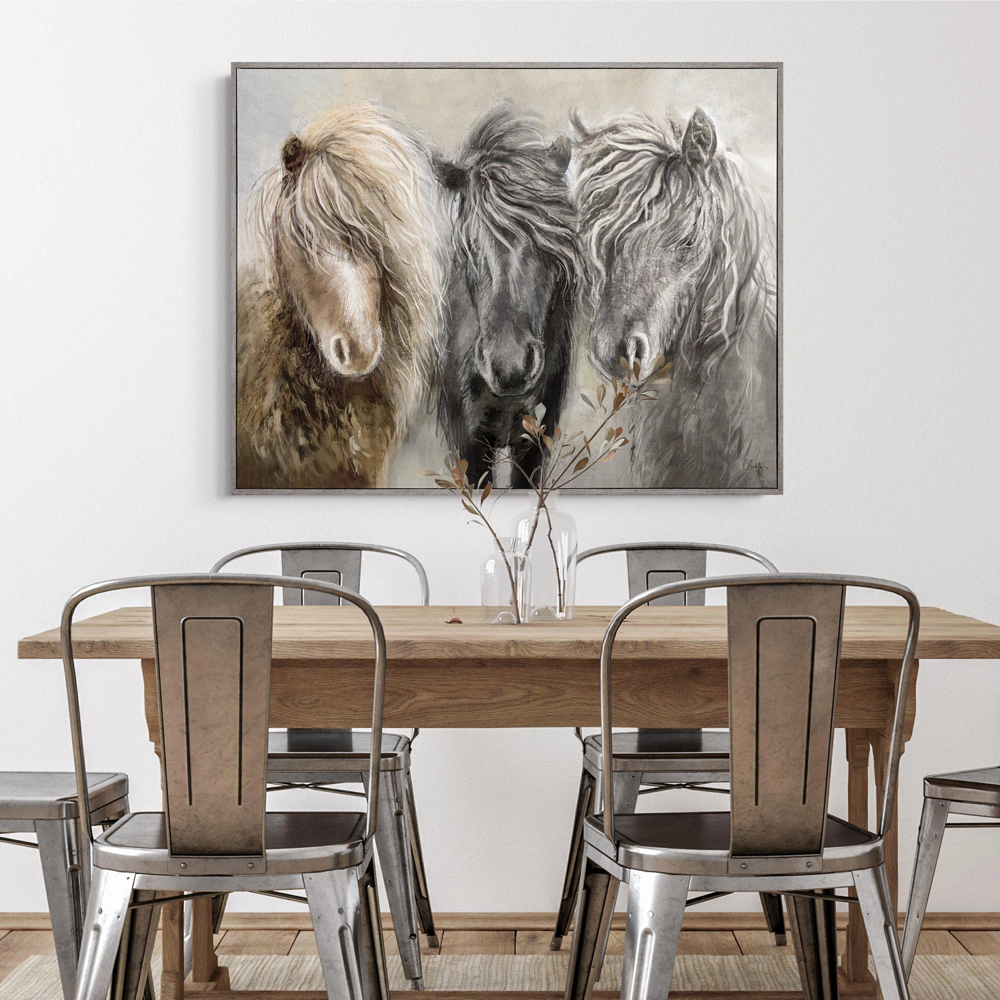 Framed canvas of three ponies in a row with an impressionist grey background of foliage hanging in light room.