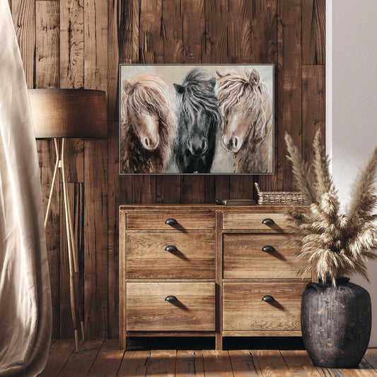 Framed canvas of three ponies in a row with an impressionist grey background of foliage on wall