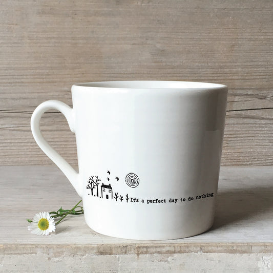 A white ceramic mug with a Farm house illustration and a quote