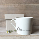 A white ceramic mug with a tea pot illustration and a quote with a box