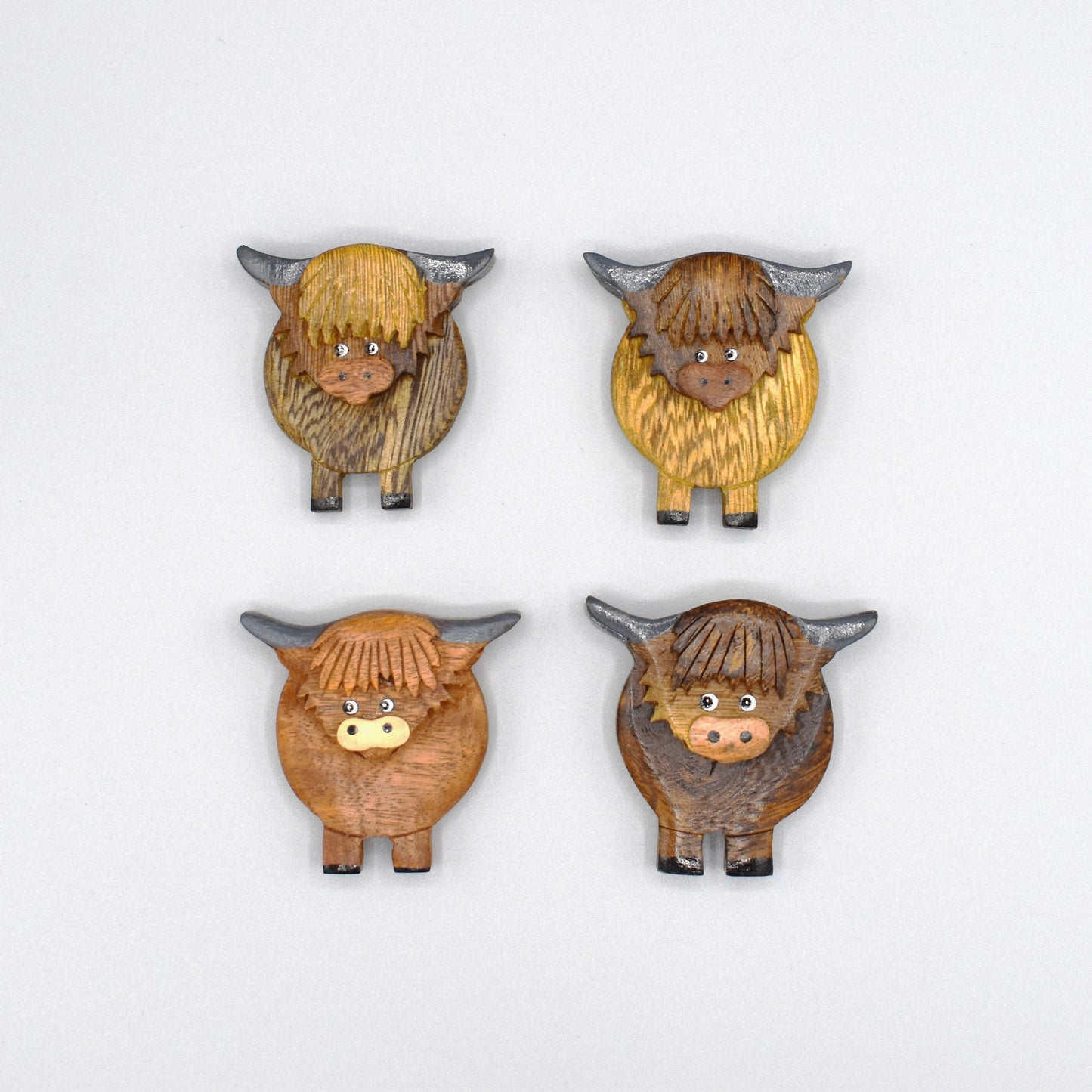 A wooden Highland cow magnet colours