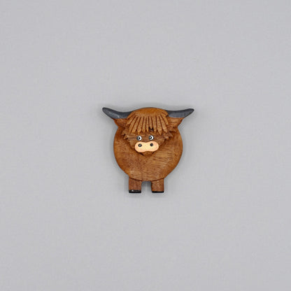 A wooden Highland cow magnet